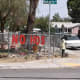 A sign in a fence attempts to ward off potential invaders