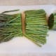 Cut the ends off of your asparagus and cut them in half.