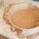 And transfer your dough over. I do this by gently folding it twice to get it off of the counter without tearing, and then unfolding it in the pie dish.