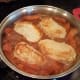 Add your pork chops back into the mix and slide them into the bottom.