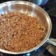 Now get your hamburger cooking in a pan on the stove over medium high heat or so. Chop your onion finely and add it to the mix as well.