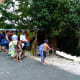 Tourists near huts where locals are braiding hair
