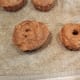 From left to right, each donut place in the pan was filled a little less. This was 3/4 full on the left, 1/2 full in the middle, and 1/4 full on the right.