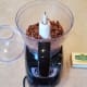 Start by blending up your almonds in the food processor.