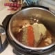 Add in your garlic, spreading it evenly throughout the pot.