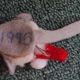 The tail and hanging loop thread are inserted inside before the bottom felt is glued.