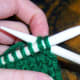 Insert working needle into the two new needles as if to knit.