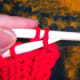 Pull the first stitch over the second stitch.