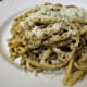 Plate the pesto-coated linguine and sprinkle with the Pecorino Romano cheese