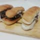 Prosperity burger according to the layers, bottom bread, patty, sauce, onions and top bread.