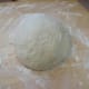Work the edges to the inside and form a ball. Let it rest on the board 5 - 10 minutes.