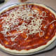 Sprinkle the shredded Mozzarella cheese over the top of the sauce.