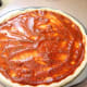 Spoon the sauce on top of the formed dough.