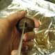 Cutting Chestnut with scissors. Cut an X on the flat side of the chestnut using either scissors, as I do here.