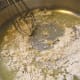 Adding and stirring the flour into the butter