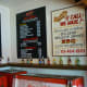 Menu on wall and drink selections can be picked up out of these old Coca-Cola coolers.