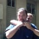 Defender pulls the attacker's choking arm off of his windpipe to release the pressure