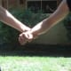 Defender pulls his fist towards his own chest and thrusts his elbow towards the attacker's arm, escaping the wrist grab