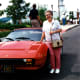 My mother is standing next to Yakov's Ferrari parked just outside the theater.