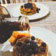 Homemade crispy waffles topped with fresh blueberries and served with maple syrup