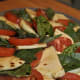 Fresh mozzarella, tomatoes and basil-seasoned with salt, pepper, and olive oil.