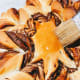 Brush the syrup all over the star bread while it still warms.