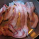 Frying hog jowl. Looks like really fatty bacon.