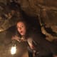 Our daughter Alissa bravely lights the way through Jewel Cave.