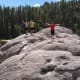 Children celebrating climbing the rocks.