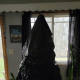 Gently place a regular-sized trash bag on top of the tree to cover the branches.