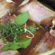 Short ribs, water, bay leaves, and thyme added to the pot and ready to cover and bake in the oven.