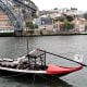 Flat bottomed boat near Ponte de Dom Luis 1, Porto.