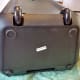 View of speaker's wheels. Note that the loose battery had bounced around during shipment, damaging the bottom of the case