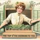 St. Patrick's Day card: Pretty woman dressed in white looking out a window "Top of the morning to you."
