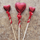 Add pizazz to your decorative hearts by wrapping a red pipe cleaner around the sticks.
