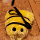 Wrap a black ribbon around the bee, tying a bow at the top to create stripes.