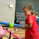 Boy in red hits ball off air tee