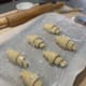 Place the croissants on a parchment-lined baking tray and let them rise for 1 hour or more.