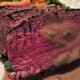 Green peppercorn sauce napped over slices of tenderloin of beef.