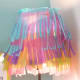 Embellish a white lampshade with rows of colored tissue paper cut into fringed lengths. Layer the tissue paper to achieve a petticoat effect.