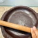 Press the dough into the shell and trim away any excess.