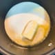 In a saucepan, bring the cream and butter up to a simmer.