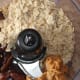 Add the oats, dates, peanut butter, and maple syrup to a food processor.
