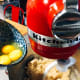 Slowly add the eggs and vanilla extract into the wet mixture and continue mixing until it is all combined.