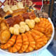 Poon Choi, or Pen Cai, is a popular Reunion Dinner dish. It means "big bowl feast" and contains different delicacies cooked in a thick stew.