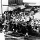 Vegetable vendors and horse-drawn wagons at the Pike Place Market, probably between 1907 and 1920