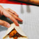 Wrap the filling by bringing the left and right sides of the dough to meet in the middle.