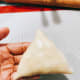 Take the bottom and fold it up to form a triangle shape. Crimp and pinch the edges to close.