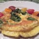 Divide it in half and serve on a heated plate garnished with tomatoes