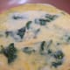 Add the beaten eggs over the top of the onion and spinach